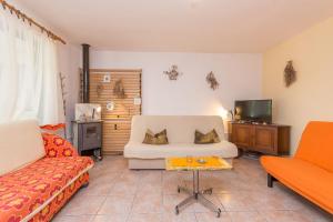 a living room with a couch and a tv at House Lady Anna in Pašman