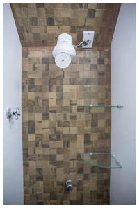 a bathroom with a glass shower with a brick wall at Promocional 3 Pessoas Vila Praia do Forte in Mata de Sao Joao +34 photos
