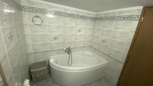 a white tub in a bathroom with a shower at Golden Flower Luxury Apartment in Sitia +21 photos