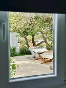 a view of a table and chairs through a window at Errika's Sweet Home in Provatas