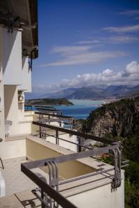 a balcony with benches and a view of the water at Hotel Villa Principe in San Nicola Arcella