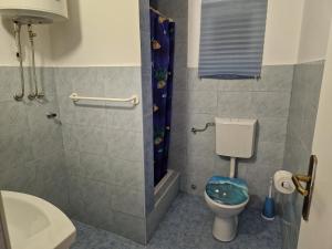 a small bathroom with a toilet and a sink at Holiday Home Gabriela in Sukošan +57 photos