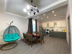 a kitchen and dining room with a table and chairs at Qafqaz Resort Wonderland in Gabala