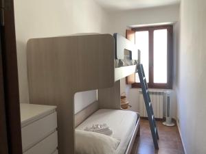 a bunk bed in a room with a window at CasaMare. Orbetello centro storico. in Orbetello