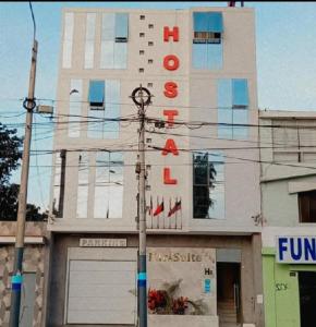 a building with a sign on the side of it at Hostal Parisuite in Lima