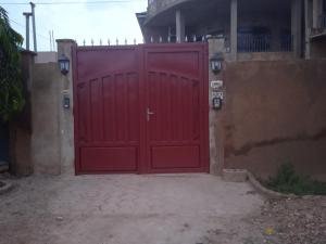 a red garage door with a cross on it at BERGET ZACA in Ouagadougou