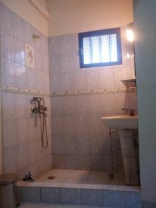 a bathroom with a shower and a sink at BERGET ZACA in Ouagadougou