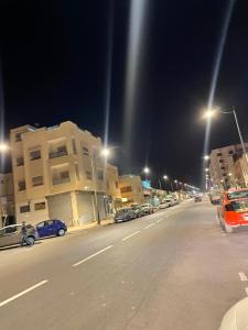 a street at night with cars parked on the street at maison souk agadir in Agadir