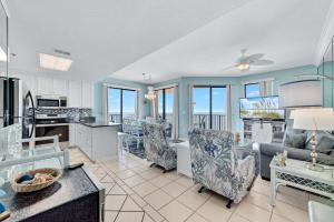 a kitchen and living room with a view of the ocean at Phoenix 5 Unit 1417 in Orange Beach