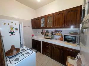 a kitchen with a stove and a white refrigerator at maison souk agadir in Agadir +6 photos
