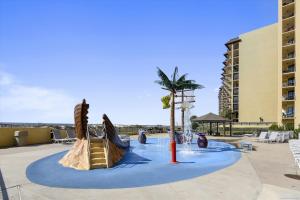 a water park with a slide and a palm tree at Phoenix 5 Unit 1417 in Orange Beach