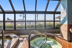 a jacuzzi tub in a building with windows at Phoenix 5 Unit 1417 in Orange Beach