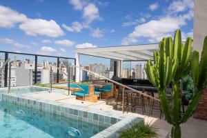 a swimming pool on the roof of a building at Life Residence in Belo Horizonte