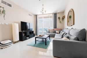 un soggiorno con divano e TV di Great Gatsby's Home a Dubai