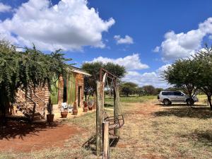 a car is parked in front of a house at Kilimanjaro view cabin-Amboseli in Oloitokitok 