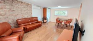 a living room with a leather couch and a table at Villa Romantica in Blato