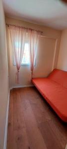 a bedroom with a red bed and a window at Villa Romantica in Blato