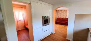 a hallway with a living room with a red couch at Villa Romantica in Blato