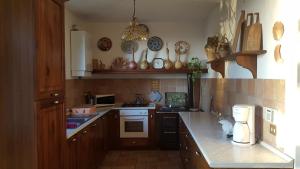 a kitchen with wooden cabinets and a counter top at La Guardata in Montefiascone