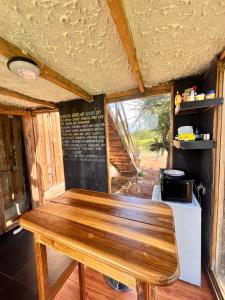 uma sala de jantar com uma mesa de madeira num quarto em Kilimanjaro view cabin-Amboseli em Oloitokitok 