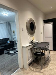 a living room with a table and a mirror on the wall at Marvellous Single Room in Middlesbrough +19 photos