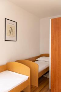 a room with two beds and a picture on the wall at Villa Pontem in Komarna
