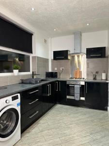a kitchen with a washing machine and a washer at Marvellous Single Room in Middlesbrough