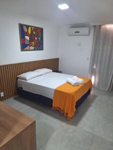 a bedroom with two beds and a painting on the wall at Morada do Francês in Praia do Frances