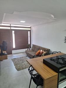 a living room with a couch and a table at Morada do Francês in Praia do Frances