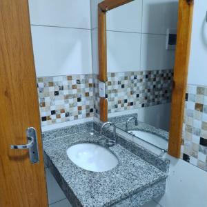 a bathroom with a sink and a mirror at Pousada Vila Jesuita in Cairu +17 photos