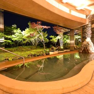 a swimming pool in a house with a garden at Hakone Gora Byakudan in Hakone