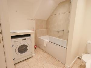 a bathroom with a washing machine and a washer at Fellcroft in Ambleside +26 photos