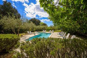 a swimming pool in a yard with chairs and trees at Villa Elizabeta in Pula