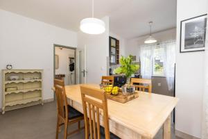 a dining room with a wooden table and chairs at Alaburic rooms & apartment in Mali Lošinj