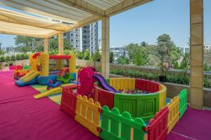 a childrens playground with colorful play equipment on a purple rug at Radisson Blu Hotel & Spa, Nashik in Nashik