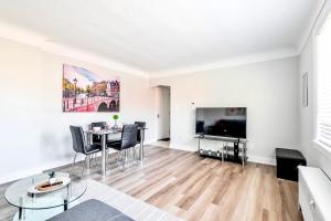a living room with a table and a tv at 1BR Apartment in Corktown Hamilton in Hamilton