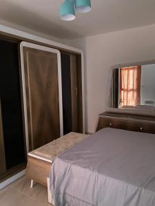 a bedroom with a bed and a window at شقة فندقية فاخرة لعشاق الهدوء والسكن الراقي في مدينتي in Madinaty +8 photos