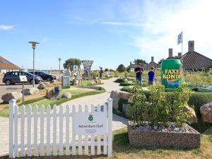 a park with a white fence and a sign at 4 person holiday home on a holiday park in Karreb ksminde in Karrebæksminde