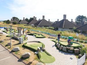 a playground with miniature golf courses in a park at 4 person holiday home on a holiday park in Karreb ksminde in Karrebæksminde