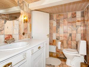 a bathroom with a sink and a toilet at 5 person holiday home in Karby-By Traum in Karby +24 photos