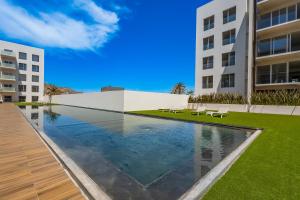 a swimming pool in the middle of a building at Marea Los Cabos Albatros 202 in Cabo San Lucas