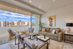 a living room with a couch and a table at Marea Los Cabos Albatros 202 in Cabo San Lucas