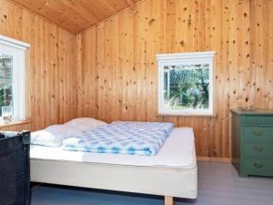 a bedroom with a bed in a wooden wall at Holiday home Thisted XXI in Sønder Vorupør