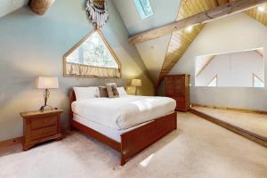 a bedroom with a large bed and a window at Marshall Haven in South Lake Tahoe