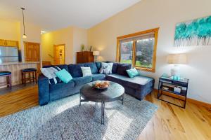 a living room with a blue couch and a table at Lake Minocqua Lakeview in Minocqua