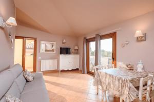 a living room with a table and a couch at OLBIA SKYVIEW ATTIC, Gaia's House in Olbia