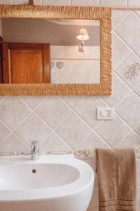 a bathroom with a sink and a mirror at OLBIA SKYVIEW ATTIC, Gaia's House in Olbia