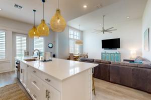 a kitchen and living room with a couch at Mimosa Manor in Port Aransas
