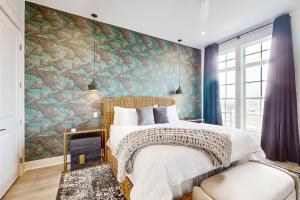a bedroom with a large bed with a stone wall at Mimosa Manor in Port Aransas