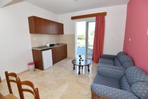 a living room with a couch and a table at Blue Serenity Apartment 5 in Ialysos